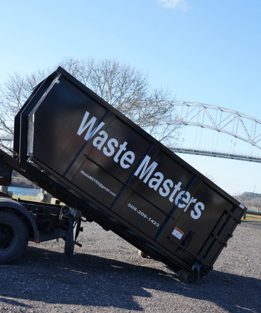 black big dumpster on the middle of a street with the waste masters logo
